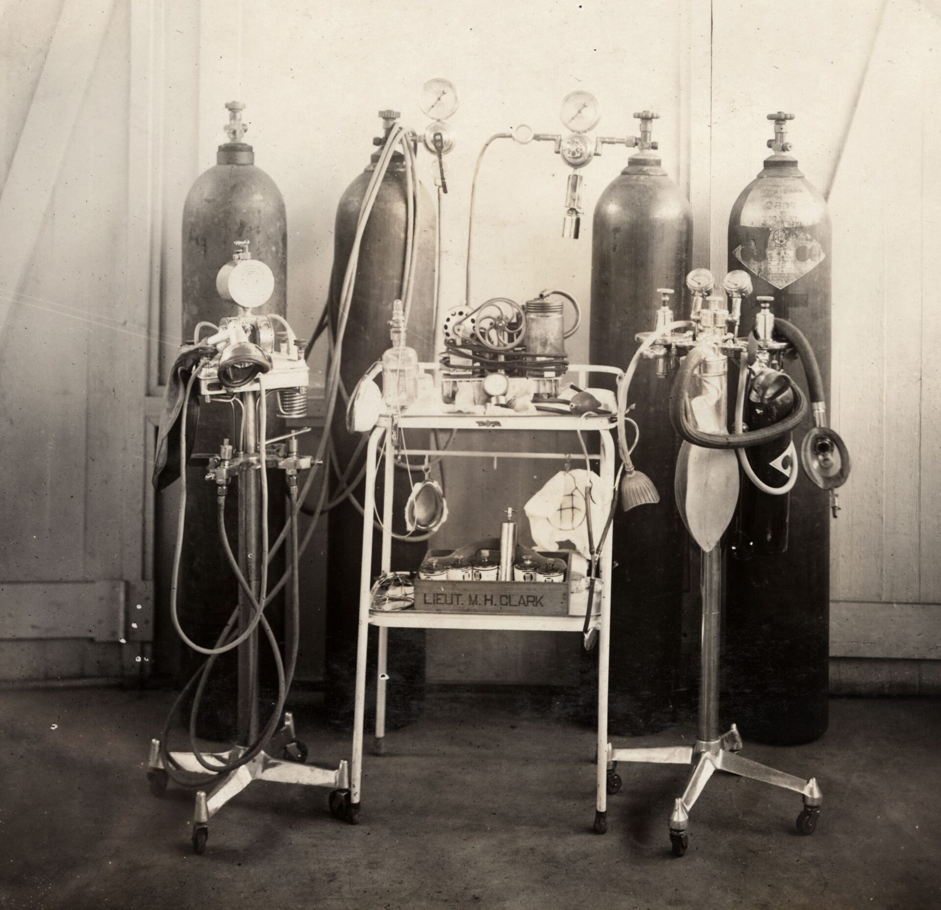 a black and white image of medical equipment. It consists of a number of containers of gas