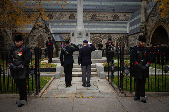 A group of soldiers saluting a cenotaph