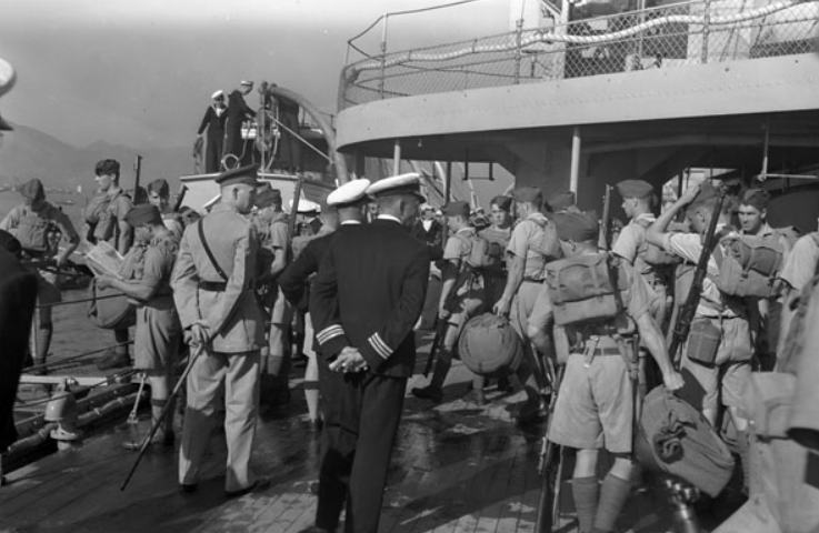 A group of soldiers getting ready to board a ship to Hong Kong.