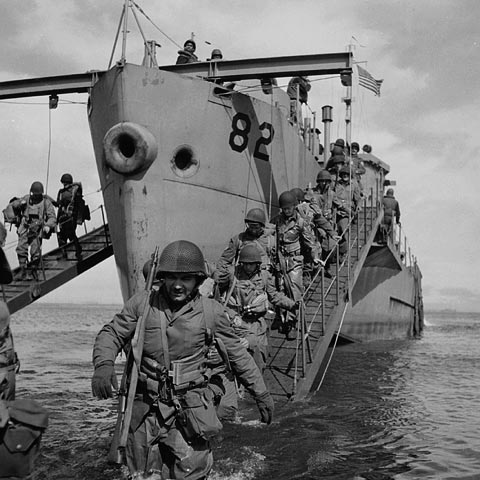 Un groupe de soldats débarquant d'un navire et se jetant à l'eau.