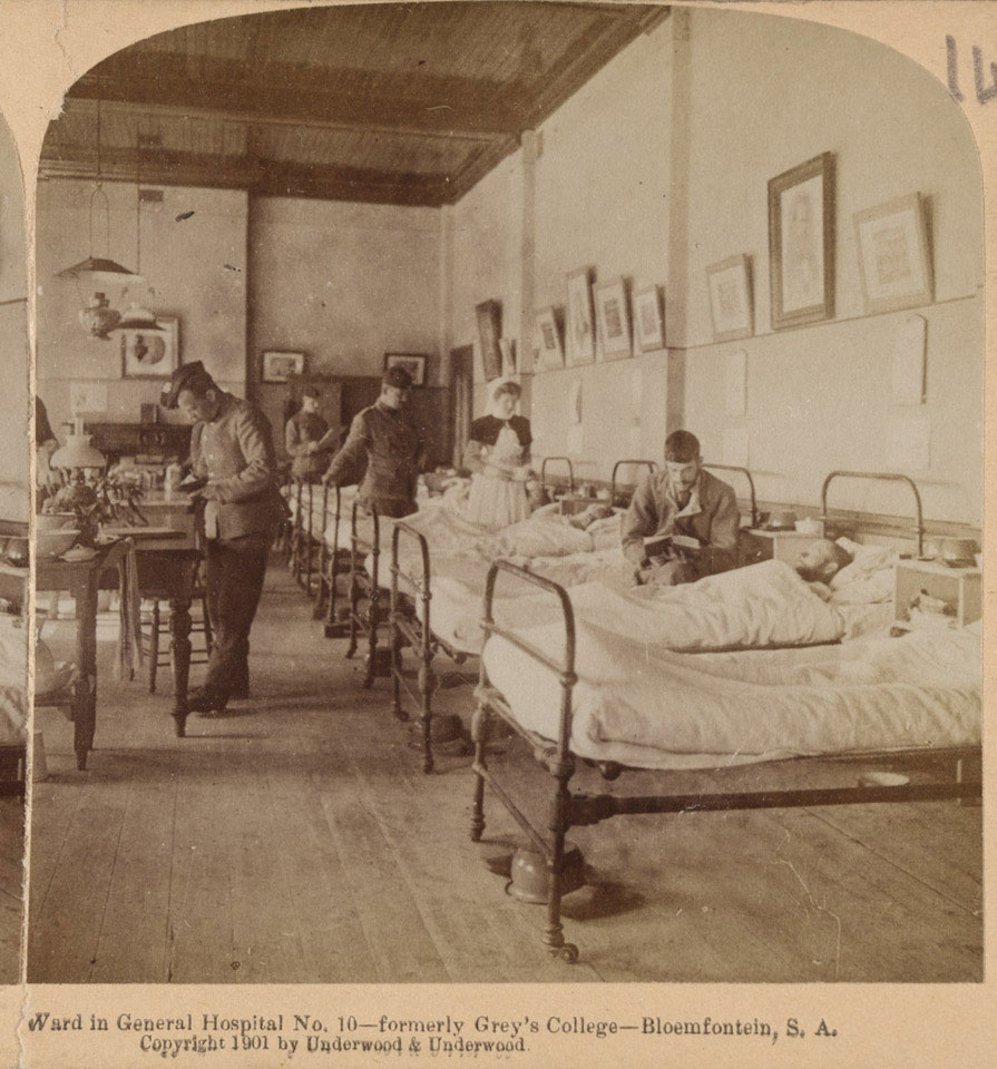 An image of a hospital ward with soldiers and a nurse. At the bottom it says "Ward in General Hospital No 10- formerly Grey's college- Bloemfontein, S A, copyright 1901 by Underwood and Underwood.